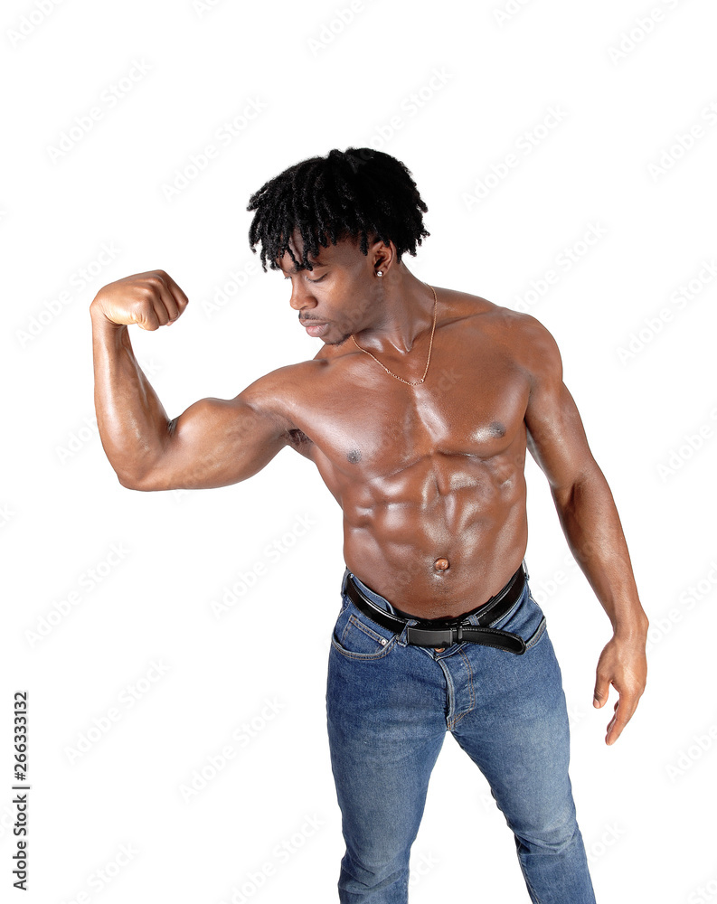 Fototapeta premium African man flexing his biceps and looking on it