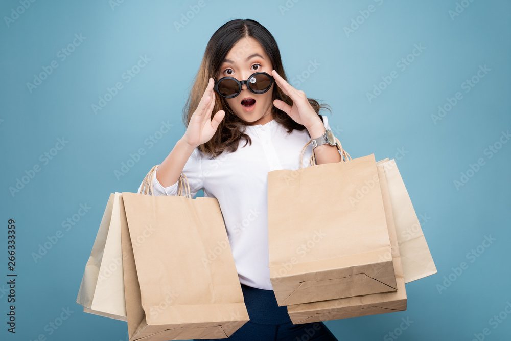 Portrait of woman holding shopping bags isolated over background Portrait of woman holding shopping bags isolated over background