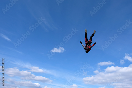 Skydiving. Girl is dancing in the sky.