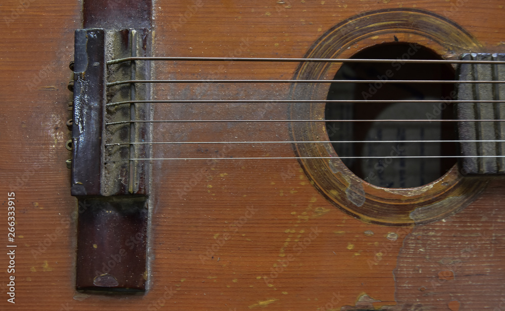 Old six-string guitar close-up. Original vintage music background