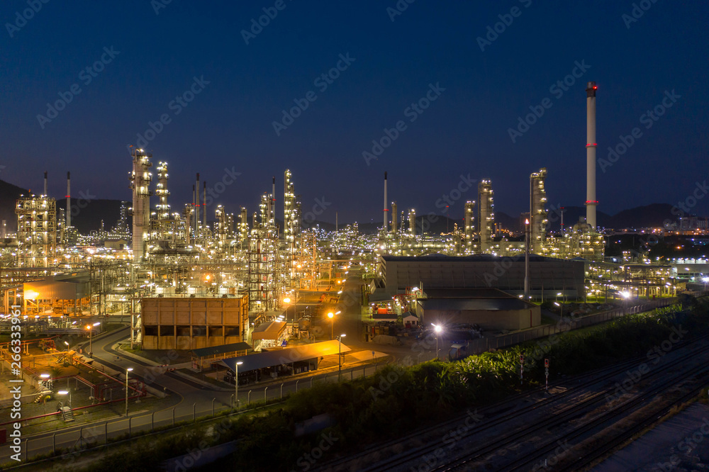Aerial view. Oil refinery factory and oil storage tank at twilight and night. Petrochemical Industrial.