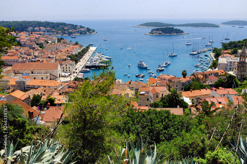Obraz premium Hvar's harbor from the Spanish Fortress with a park in the foreground. Hvar is one of the most popular tourist destination of Croatia