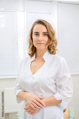 Portrait of nurse in hospital. Young doctor  intern in clinic in work place