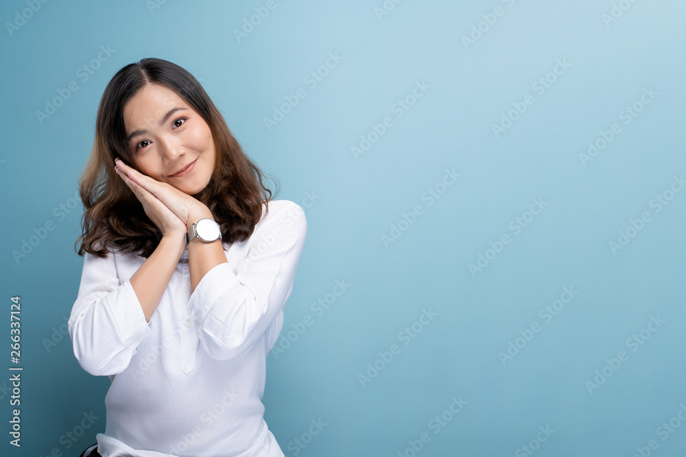 Happy woman thinking and standing isolated over blue background Happy woman thinking and standing isolated over blue background