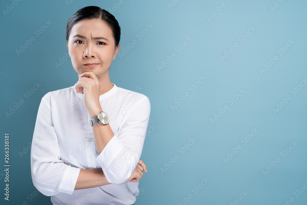 Woman feel confused isolated over blue background Woman feel confused isolated over blue background