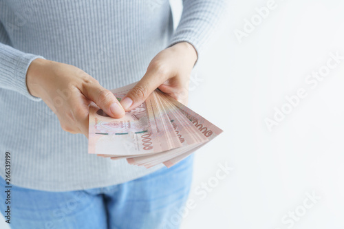 Obraz na plátně Asian woman hand counting money on white background