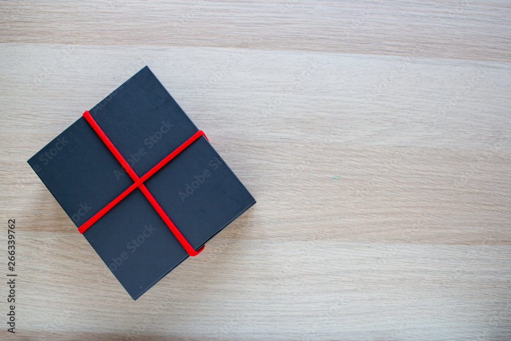 Gray gift box on wooden background