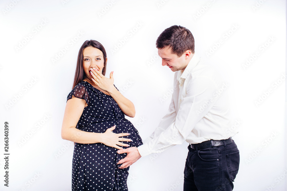 Surprised pregnant young woman waiting for her child with a surprised husband. Surprised pregnant young woman waiting for her child with a surprised husband.