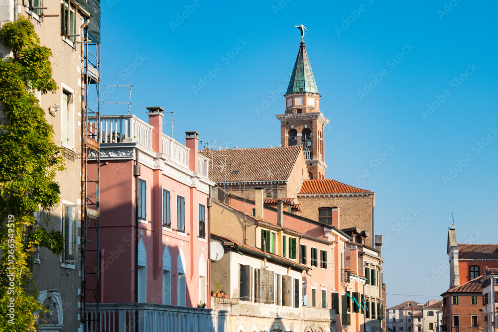 tower of San Giacomo church and houses in Chioggioa, Italy