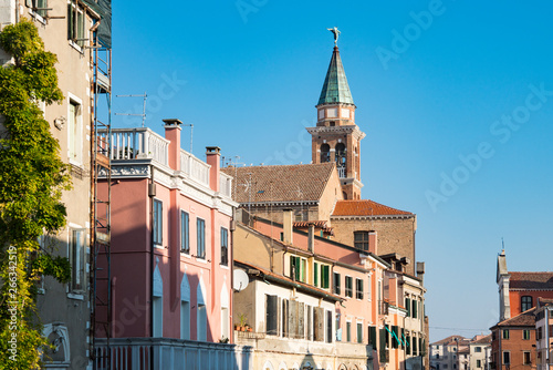 tower of San Giacomo church and houses in Chioggioa, Italy photo