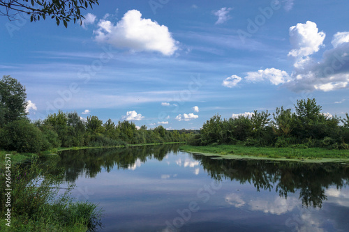 Beautiful summer landscape with pretty river and colorful trees. View of the sky with beautiful clouds. Stock photo © subjob