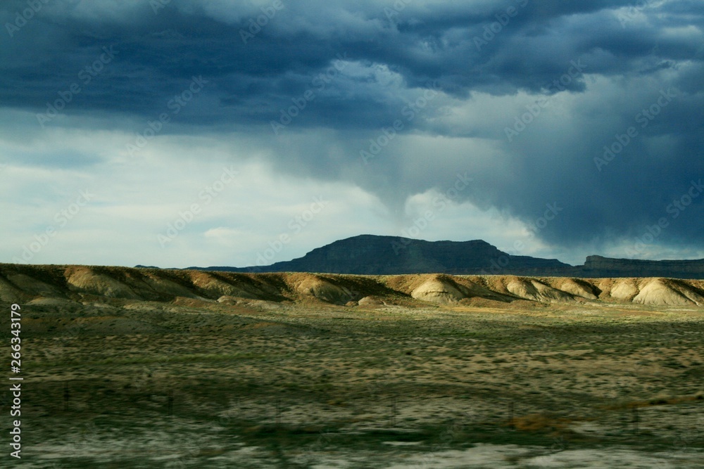 Fototapeta premium Tornado far away in Utah over the hills.