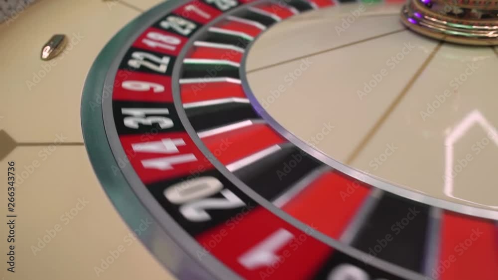 Roulette table in casino, with many games and slots, roulette wheel in the foreground. Golden and luxury light, casino interior. Gambling is the wagering of money or playing games of chance for money Roulette table in casino, with many games and slots, roulette wheel in the foreground. Golden and luxury light, casino interior. Gambling is the wagering of money or playing games of chance for money