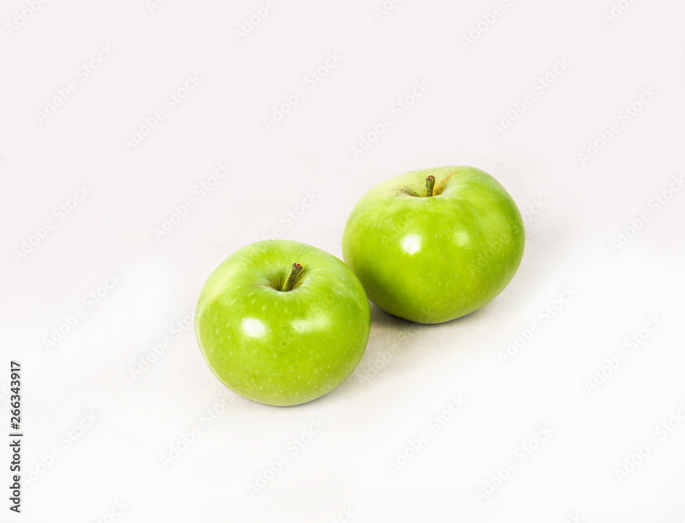 Two lovely green juicy apples on a white isolated background. Vegetarian food. Stock photo Two lovely green juicy apples on a white isolated background. Vegetarian food. Stock photo