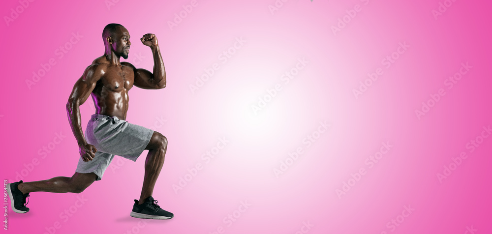 Young african-american bodybuilder training over pink studio background. Muscular single male model in sportwear. Concept of sport, bodybuilding, healthy lifestyle. Ad flyer. Negative space. Collage.