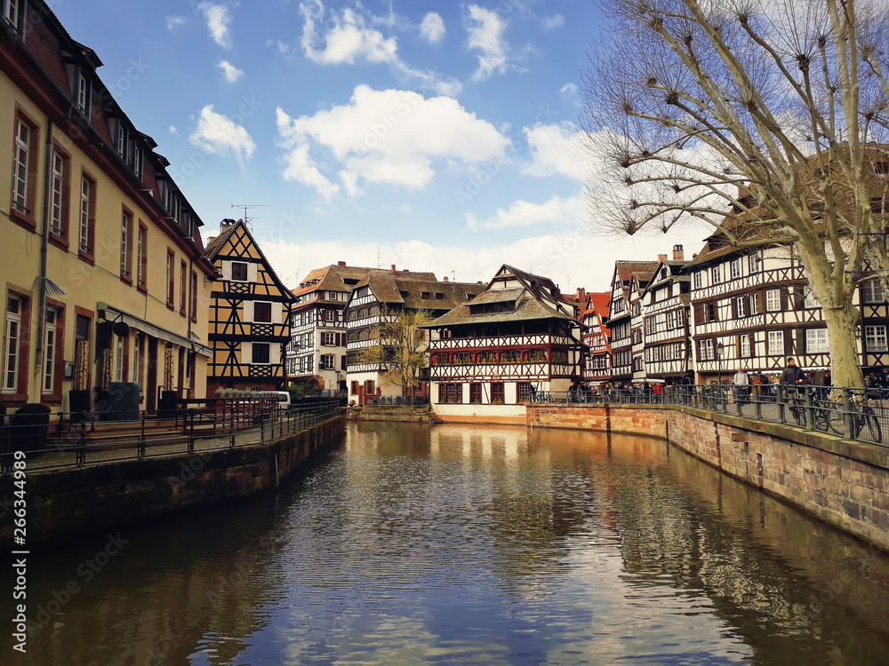 Traditional timbered houses near the river in romantic city Strasbourg, France.