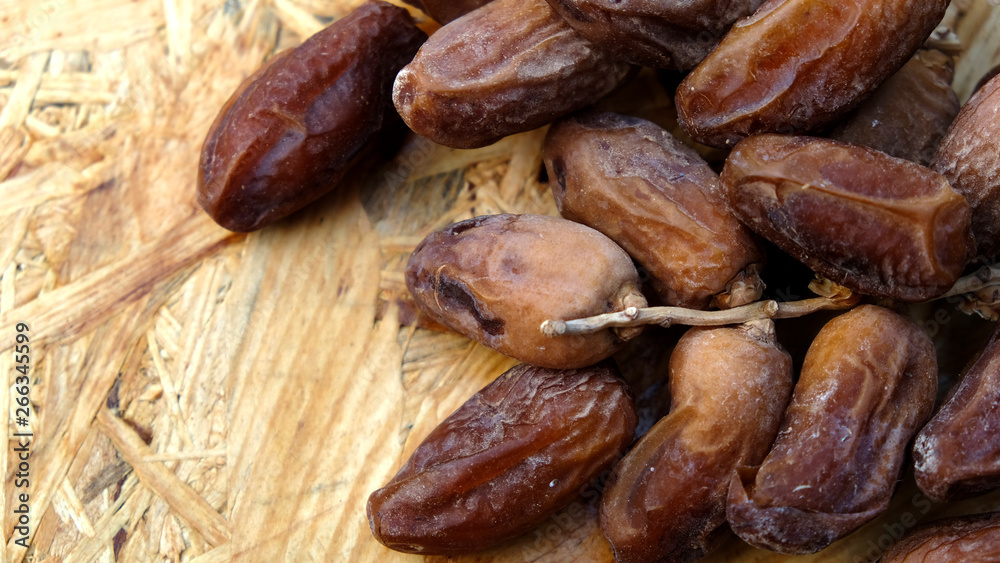 Dates in a wooden box under the afternoon sun Dates in a wooden box under the afternoon sun