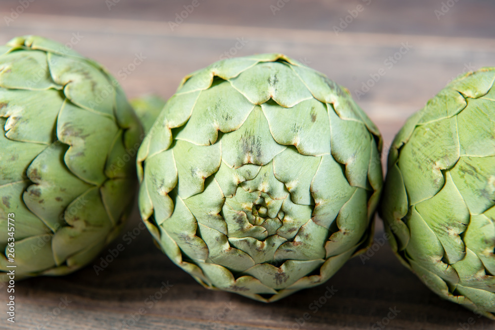 Fototapeta premium delicious organic artichokes on the wooden table