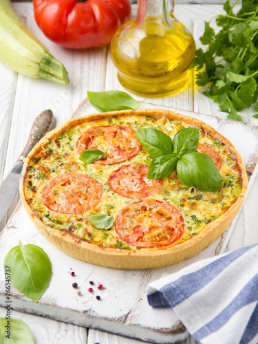 Quiche with vegetables (squash, tomatoes, cheese, herbs, green onions), open tart, French cuisine, traditional pastries