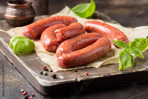 Raw grilled sausages with meat (beef, pork, lamb) and spices, hot merguez, kabanos, chorizo. Delicious food for picnic photo