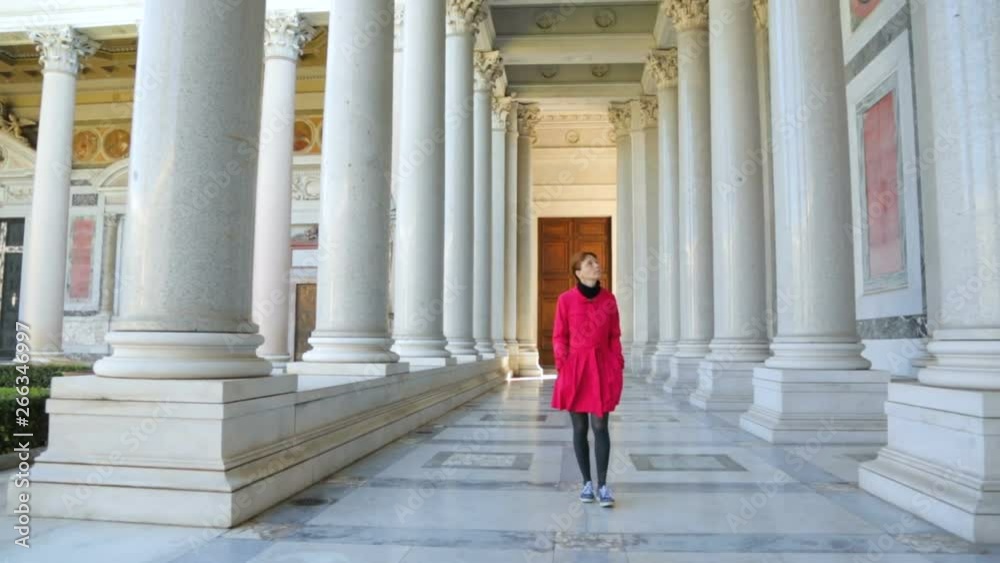 Woman walking along the columns in Basilica of Saint Paul Woman walking along the columns in Basilica of Saint Paul