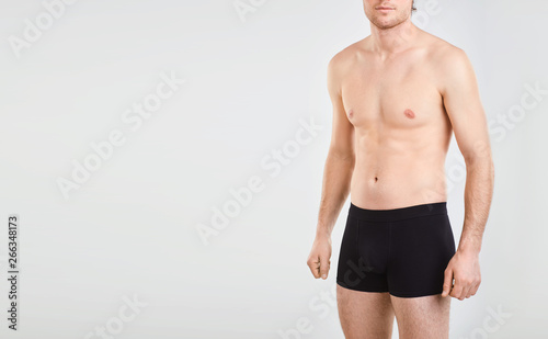 Guy in underwear on a gray background.