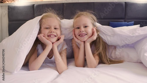 Funny twins hiding under the covers