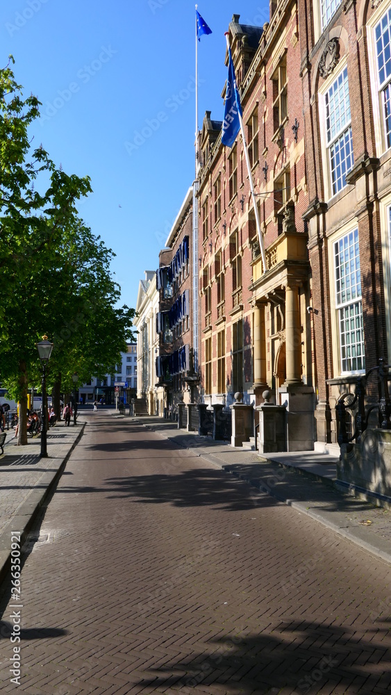 A narrow street near a canal in the City of the Hague, The Netherlands