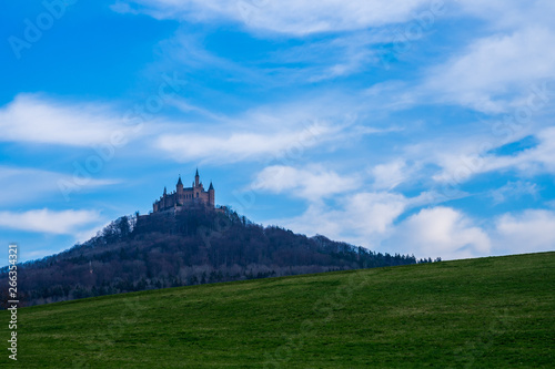 Germany, Fairytale castle hohenzollern upon forest covered mountain in swabian alb region