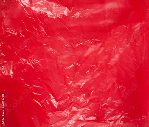 Red plastic bag close-up. Bright shiny background.