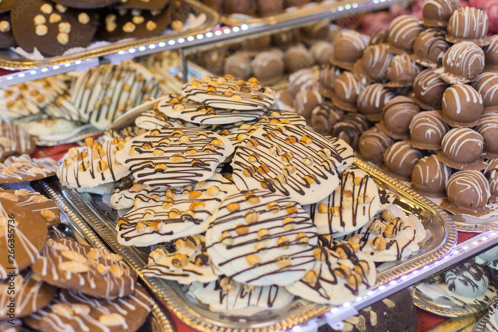 Selling sweets at a street fair in Budapest. Chocolate cookies of different tastes on the counter.