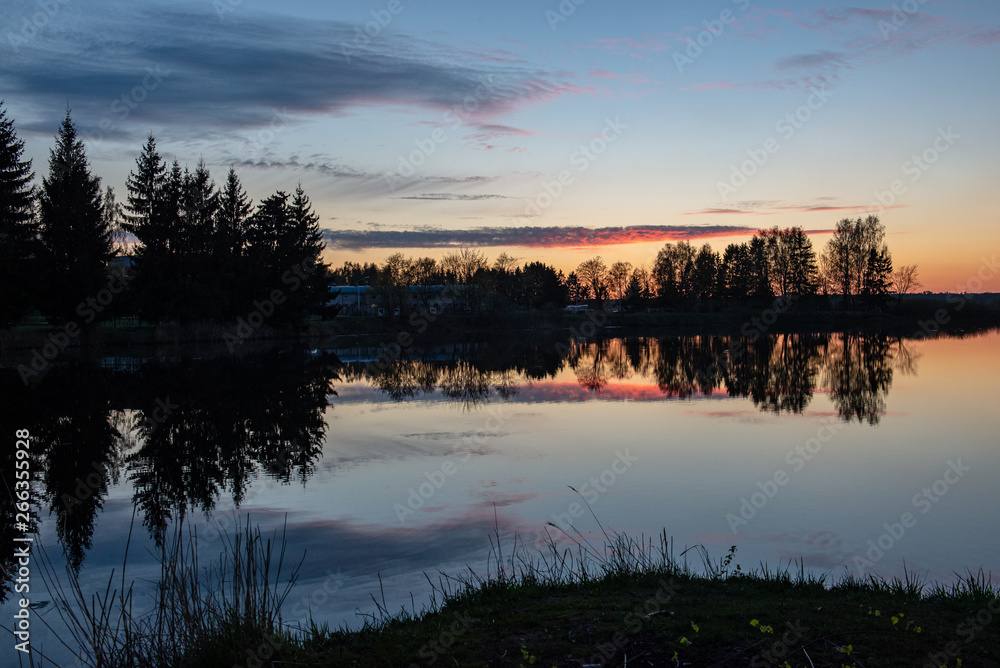 colorful sunset over the sea lake with dark red clouds colorful sunset over the sea lake with dark red clouds