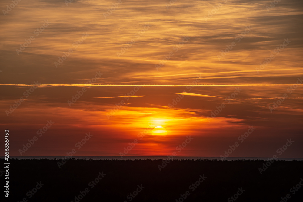 colorful sunset over the sea lake with dark red clouds colorful sunset over the sea lake with dark red clouds