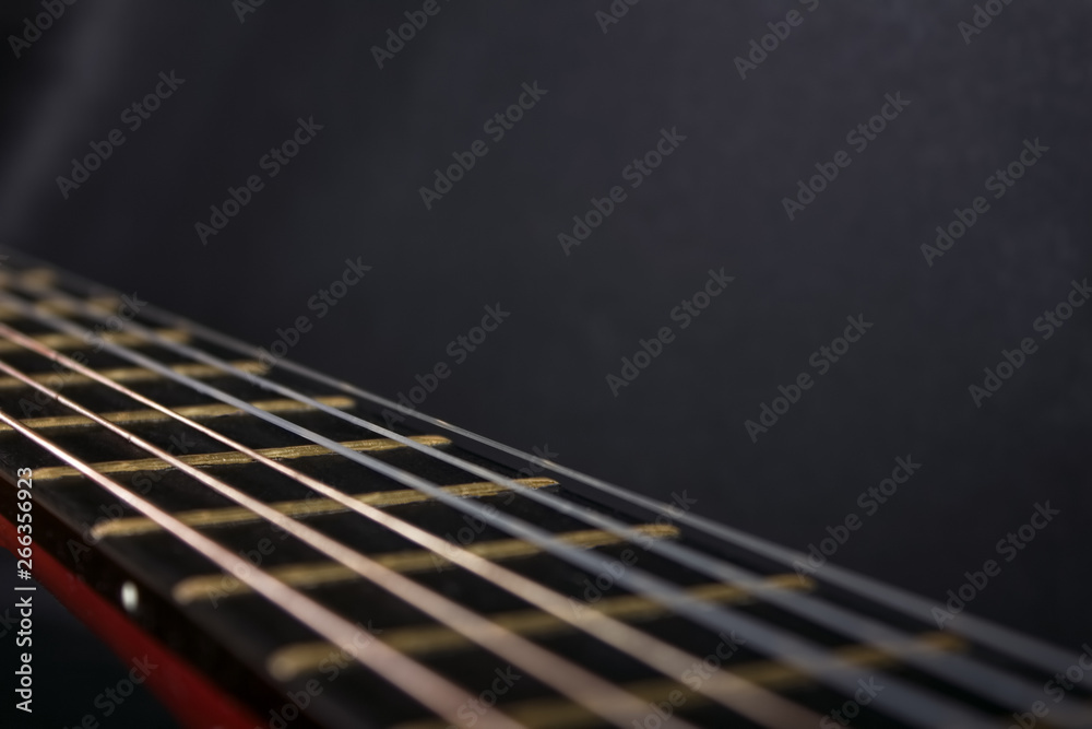 Fototapeta premium Fretboard and guitar strings on a gray background