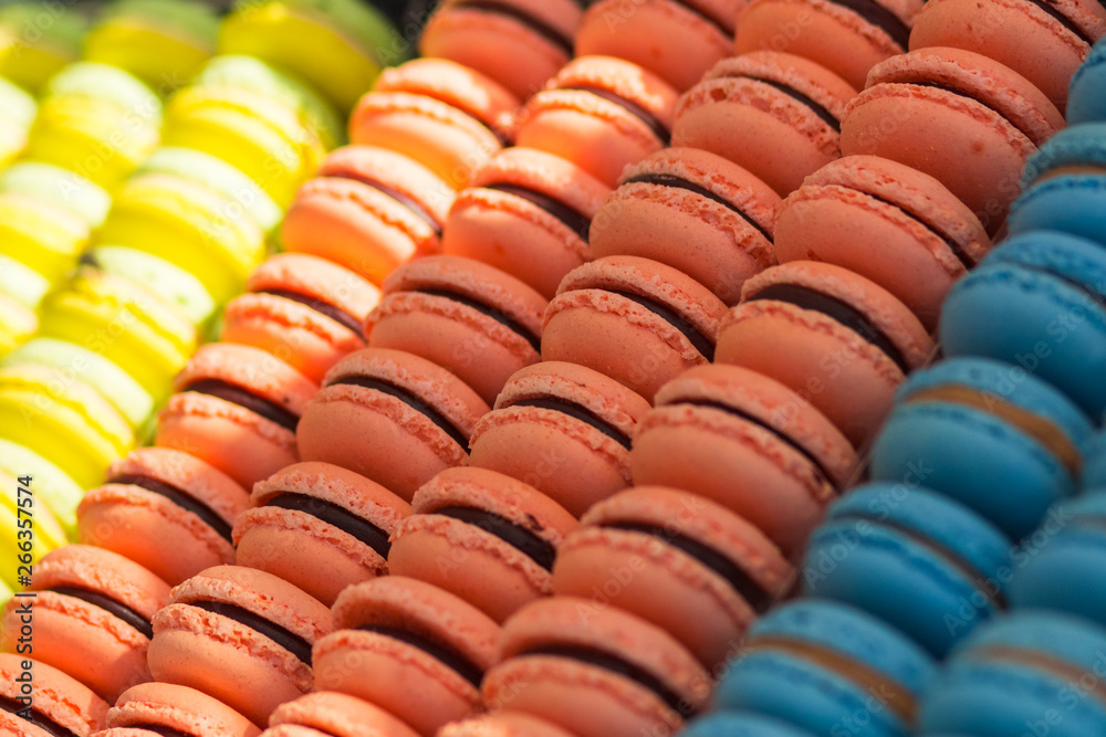 Colorful french macarons dessert with vintage pastel tones, close up. Tasty sweet color macaroon, bakery concept.