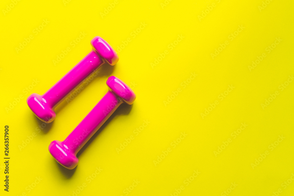 Fitness equipment dumbbells on color background. Flat lay. Fitness equipment dumbbells on color background. Flat lay.