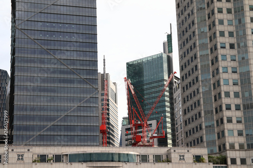 A small corner in a large building with red crane under construction
