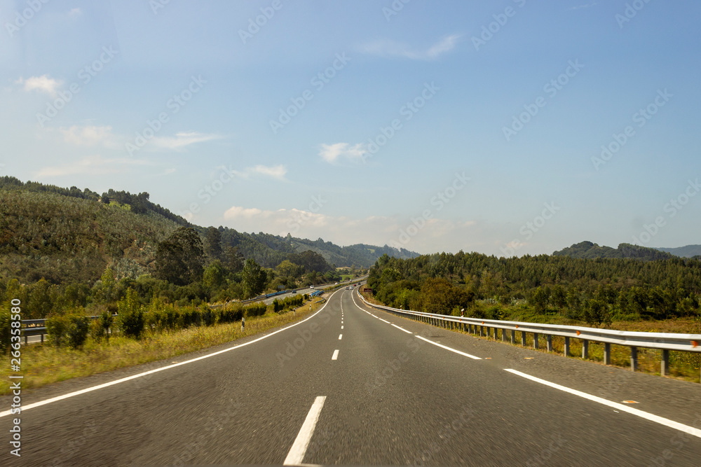 Empty road in the middle of Europe surrounded by green nature Empty road in the middle of Europe surrounded by green nature