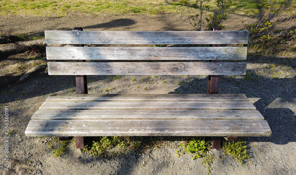 An old wood bench in the outdoor park on the evening time. An old wood bench in the outdoor park on the evening time.