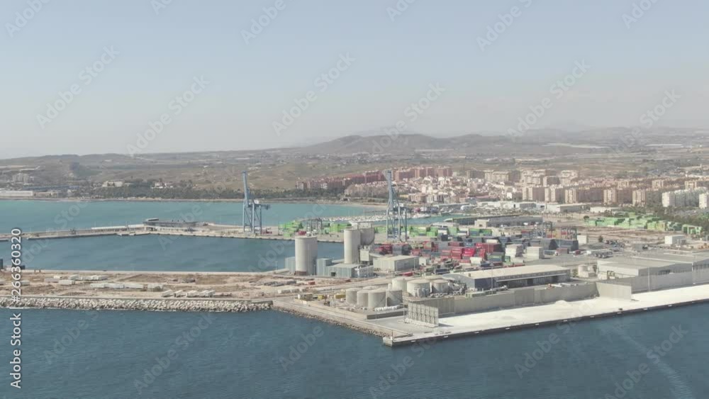 A beautiful wide slow-moving aerial shot of the Alicante harbor in Spain surrounded by the magnificent landscape and mountains on a beautiful summer day. Film LUT and grade added. A beautiful wide slow-moving aerial shot of the Alicante harbor in Spain surrounded by the magnificent landscape and mountains on a beautiful summer day. Film LUT and grade added.