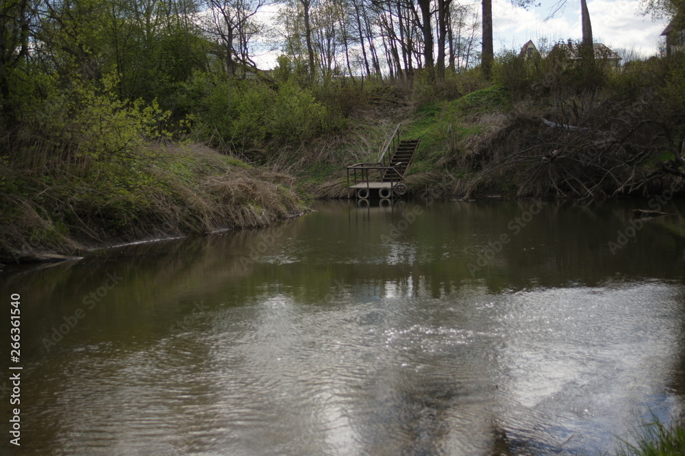 River in the forest. Spring landscape in sunny warm weather. Camping. Photo background. River in the forest. Spring landscape in sunny warm weather. Camping. Photo background.