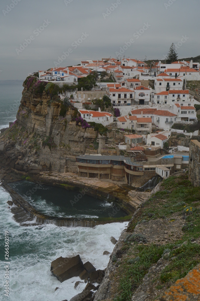 Views Of The Houses Perfectly Located On A Cliff And With A Natural Pool On Their Background In Colares. Nature, architecture, history. April 14, 2014. Colares, Sintra, Lisbon, Portugal.