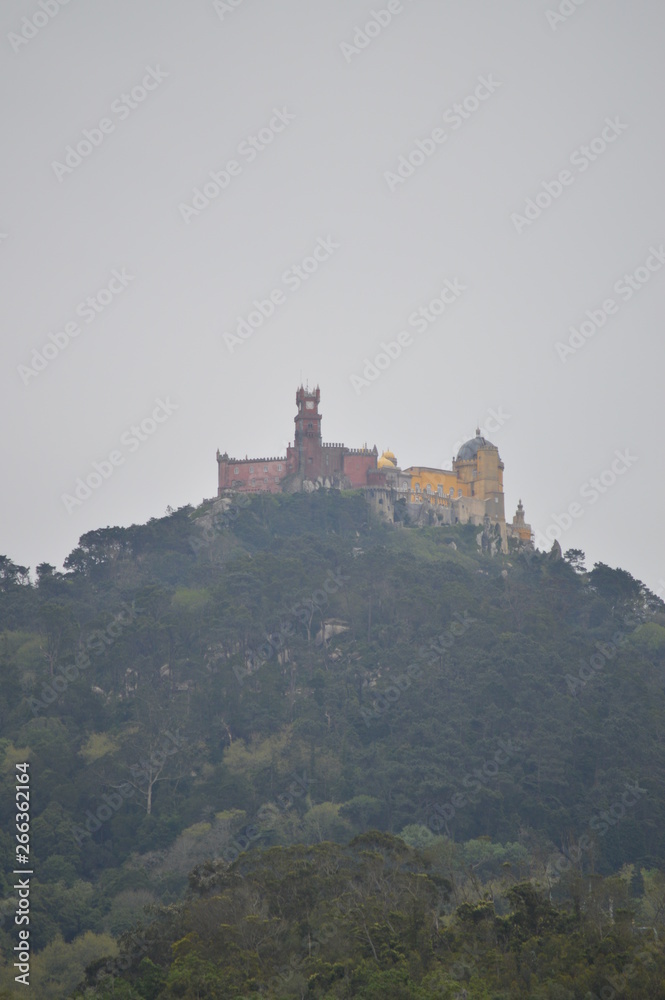 Wonderful Views Of The Palace Of Pena At The Top Of A Cliff On A Cloudy Day In Colares. Nature, architecture, history. April 14, 2014. Colares, Sintra, Lisbon, Portugal.