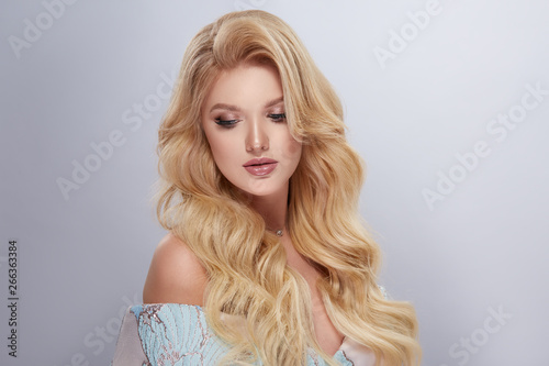 sexy lady with volume hair and evening make-up looking down