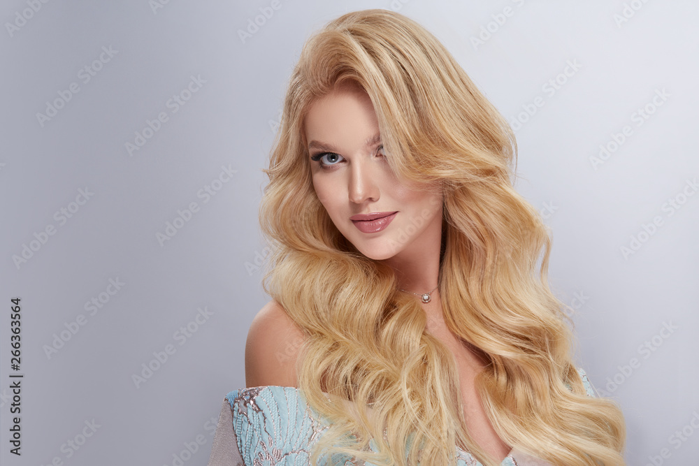 caucasian white woman with curly and shiny hair looking into camera