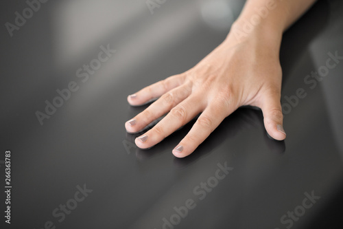 technology and people concept - hand using black interactive panel