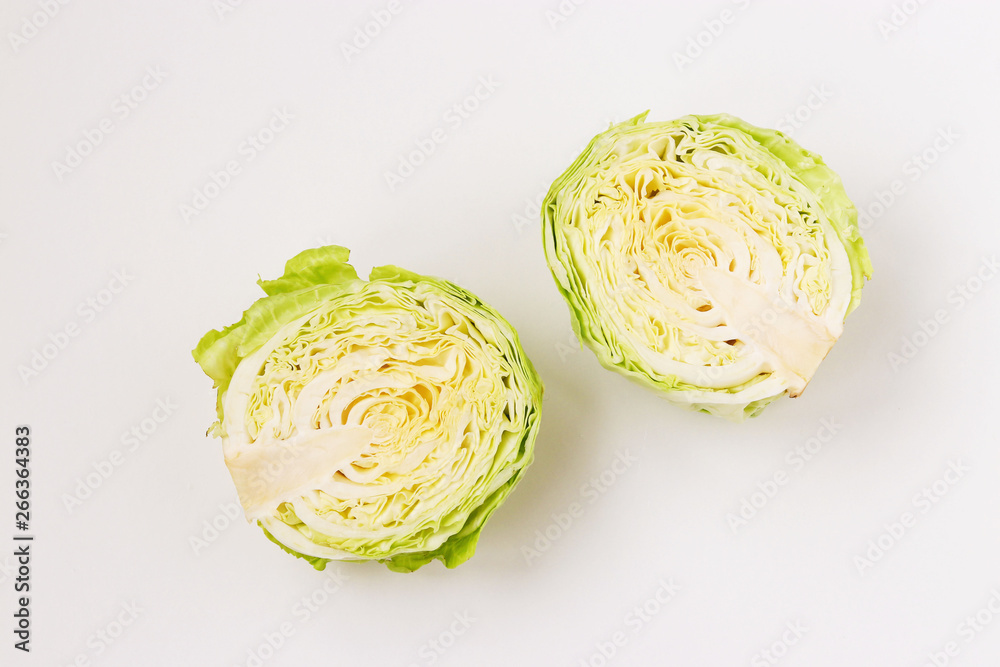 Cabbage halves are located on a white background Cabbage halves are located on a white background
