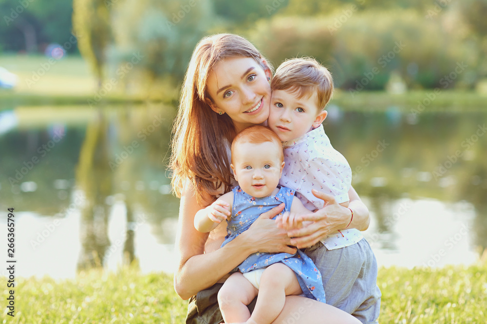 Happy mother with children in summer park. Happy mother with children in summer park.
