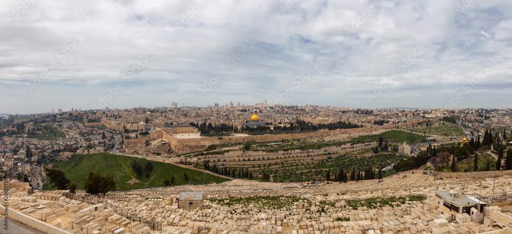 Beautiful panoramic aerial view of the Old City, Tomb of the Prophets and Dome of the Rock during a sunny and cloudy day. Taken in Jerusalem, Capital of Israel. Beautiful panoramic aerial view of the Old City, Tomb of the Prophets and Dome of the Rock during a sunny and cloudy day. Taken in Jerusalem, Capital of Israel.