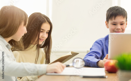 Preteen Children Doing Homework In Classroom At School